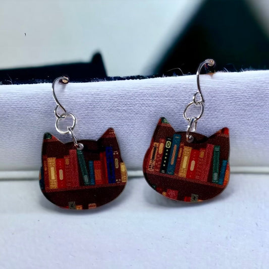 Cat shaped earrings featuring books